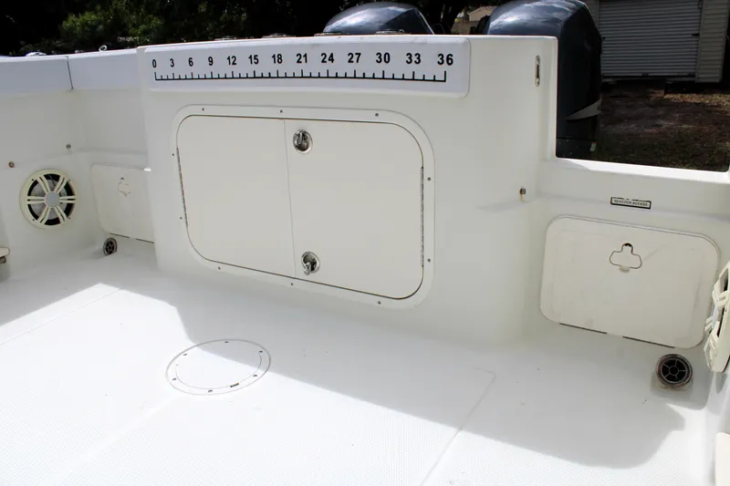 Slide: The Image of 2008 Sailfish 2660 CC boat deck with storage compartments and measurement scale. - 10