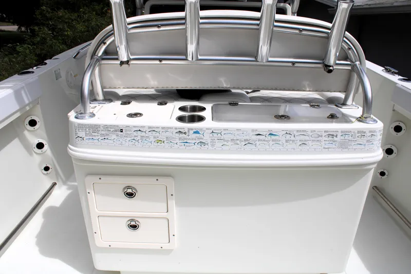 Slide: The Image of 2008 Sailfish 2660 CC boat console with rod holders and storage compartments. - 14