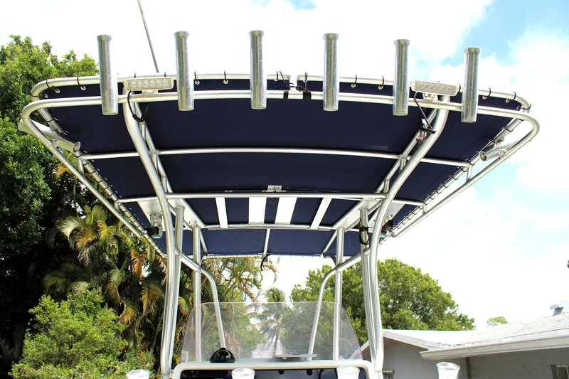 Slide: The Image of 2008 Sailfish 2660 CC boat with T-top and rod holders against a clear sky. - 17