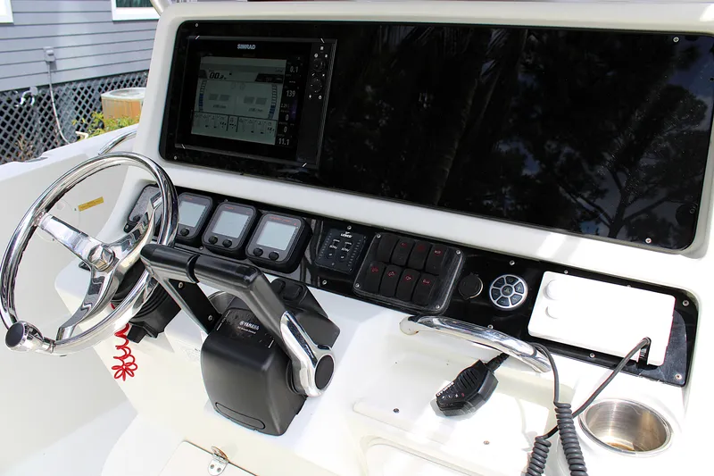 Slide: The Image of Console of 2008 Sailfish 2660 CC boat with steering wheel and electronic controls. - 18