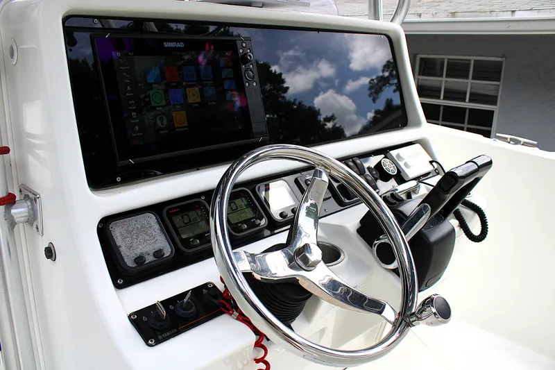 Slide: The Image of 2008 Sailfish 2660 CC boat helm with steering wheel and electronic controls. - 19