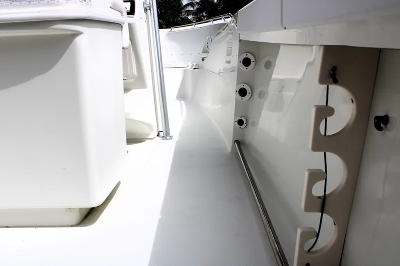 Slide: The Image of 2008 Sailfish 2660 CC boat interior with rod holders and storage compartments. - 23