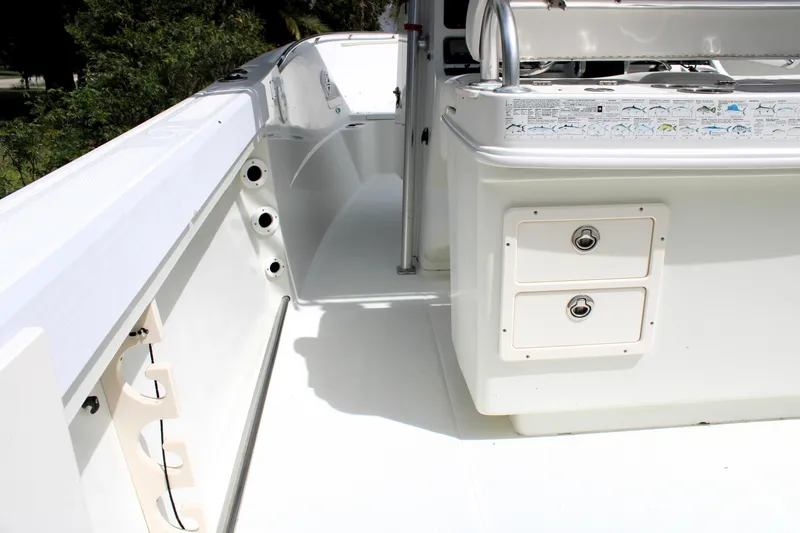 Slide: The Image of 2008 Sailfish 2660 CC boat interior, featuring storage compartments and rod holders. - 24