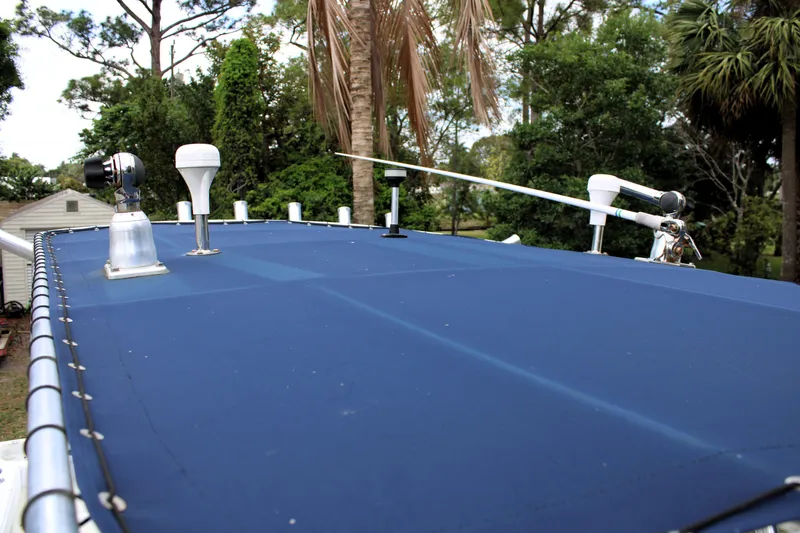 Slide: The Image of Rooftop of 2008 Sailfish 2660 CC boat with antennas and equipment, surrounded by trees. - 27