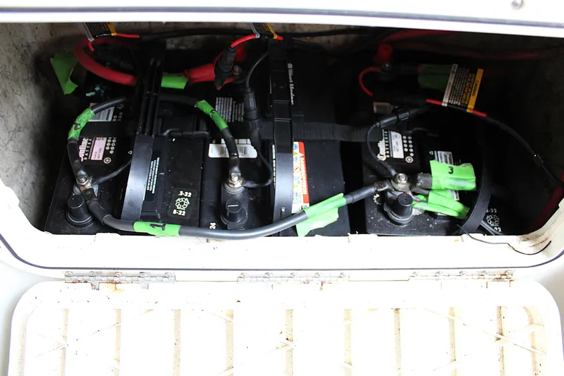 Slide: The Image of Batteries in a 2008 Sailfish 2660 CC boat compartment, with connected cables. - 28