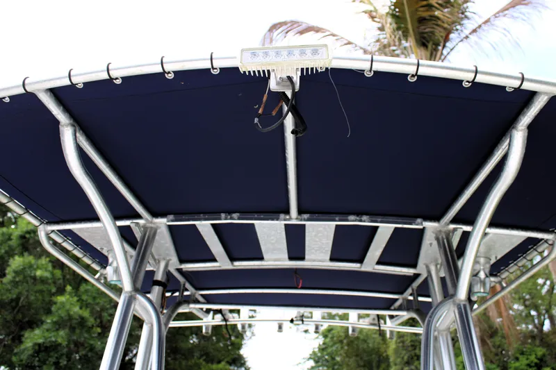 Slide: The Image of T-top canopy of 2008 Sailfish 2660 CC boat with blue fabric and metal frame. - 31