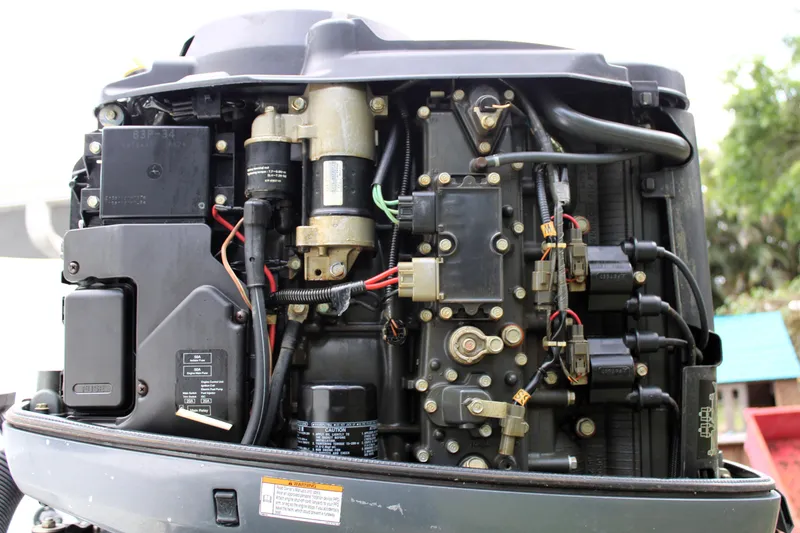 Slide: The Image of Close-up of a 2008 Sailfish 2660 CC boat engine, showcasing intricate mechanical components. - 38