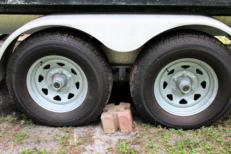 Slide: The Image of Trailer wheels of a 2008 Sailfish 2660 CC boat, supported by bricks. - 45