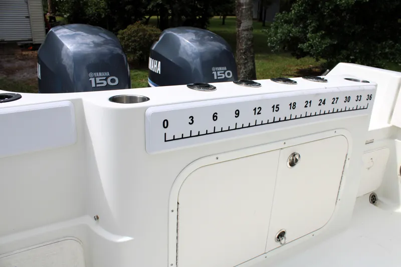 Slide: The Image of 2008 Sailfish 2660 CC boat with Yamaha 150 engines and measuring scale. - 9