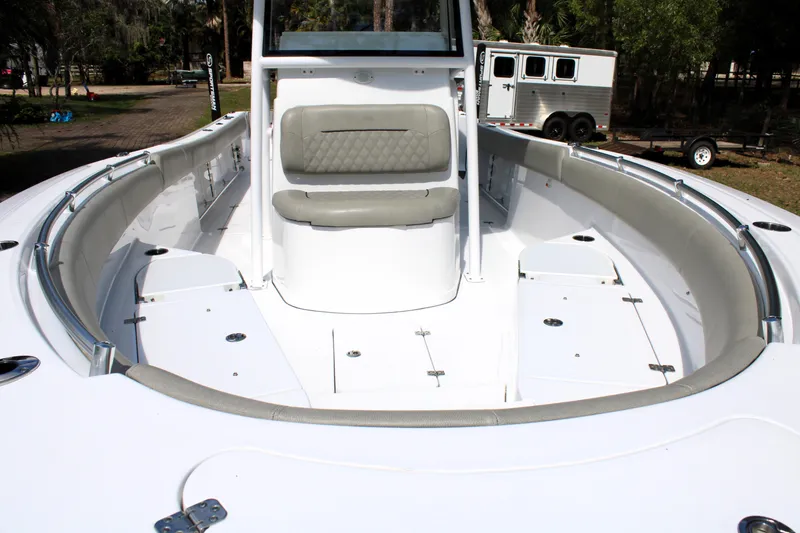 Slide: The Image of 2021 Sportsman Open 282 Center Console boat interior with cushioned seating and storage compartments. - 12