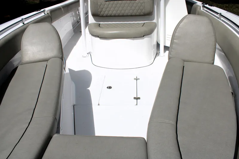 Slide: The Image of 2021 Sportsman Open 282 Center Console boat interior with cushioned seating. - 13