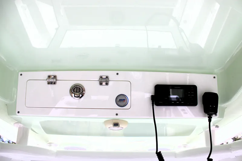 Slide: The Image of 2021 Sportsman Open 282 Center Console dashboard with Garmin electronics and storage compartment. - 20