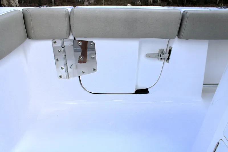 Slide: The Image of 2021 Sportsman Open 282 Center Console boat interior with cushioned seating and stainless steel hardware. - 28