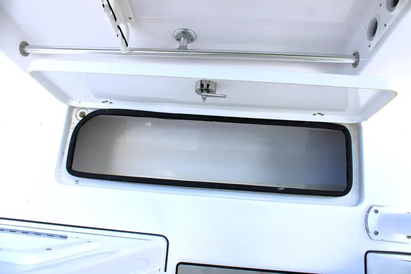 Slide: The Image of Open storage compartment on a 2021 Sportsman Open 282 Center Console boat. - 35