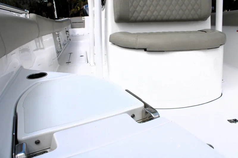 Slide: The Image of 2021 Sportsman Open 282 Center Console interior with cushioned seating and storage. - 37
