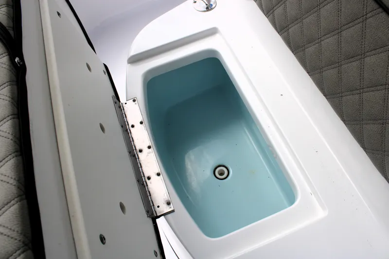 Slide: The Image of 2021 Sportsman Open 282 Center Console boat's storage compartment with cushioned seating. - 39