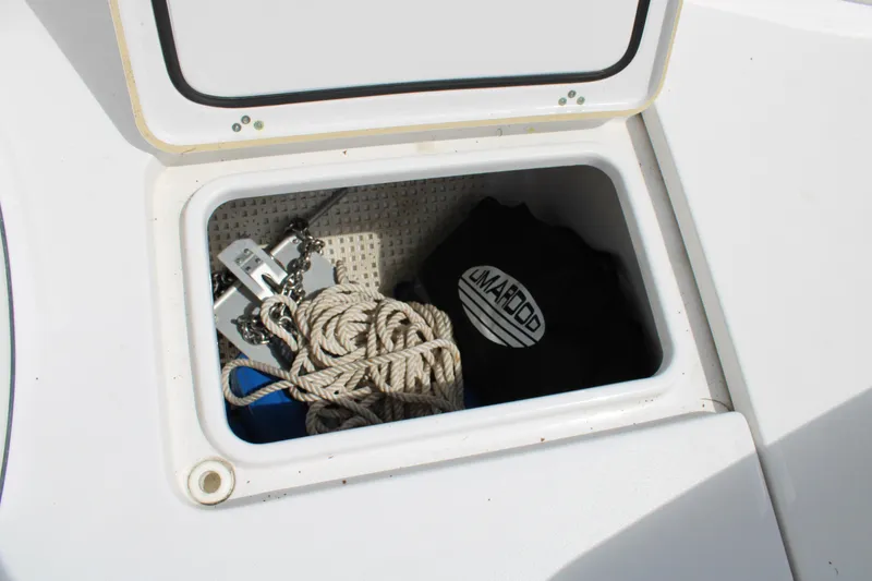 Slide: The Image of Storage compartment on a 2021 Sportsman Open 282 Center Console with rope and anchor. - 41