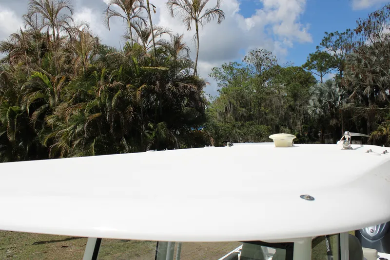 Slide: The Image of 2021 Sportsman Open 282 Center Console boat roof with lush greenery background. - 45
