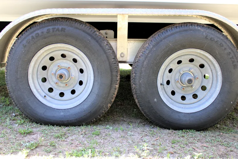 Slide: The Image of Trailer wheels of a 2021 Sportsman Open 282 Center Console boat. - 47