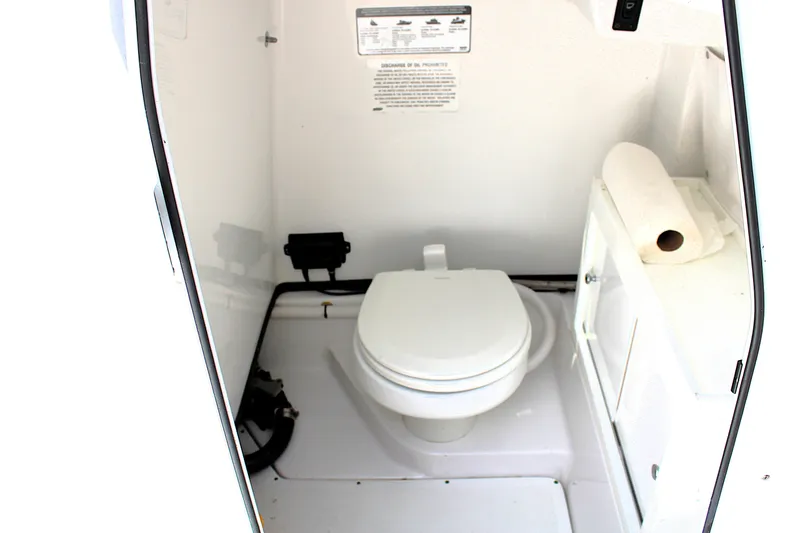 Slide: The Image of 2021 Sportsman Open 282 Center Console boat interior with toilet and storage cabinet. - 8