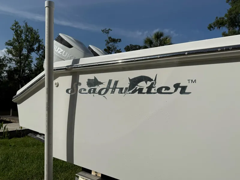 Slide: The Image of 2023 SeaHunter 28 Floridian boat with Suzuki engine, side view, outdoors. - 12