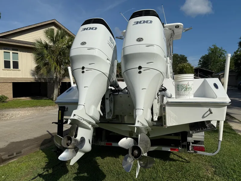 Slide: The Image of 2023 SeaHunter 28 Floridian boat with dual 300 horsepower engines, parked outdoors. - 15
