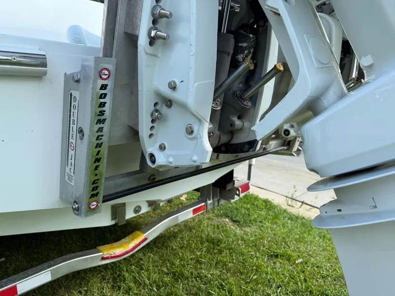 Slide: The Image of 2023 SeaHunter 28 Floridian boat engine detail on trailer, showcasing mechanical components. - 18