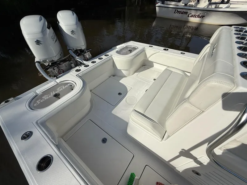 Slide: The Image of 2023 SeaHunter 28 Floridian boat interior with dual engines and seating. - 23