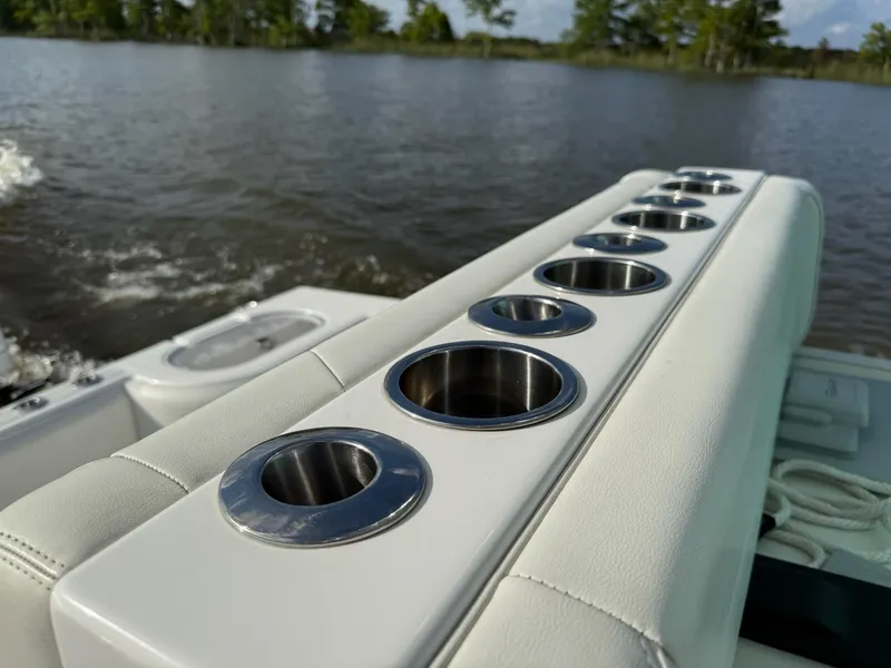 Slide: The Image of 2023 SeaHunter 28 Floridian boat with multiple cup holders on a calm lake. - 31