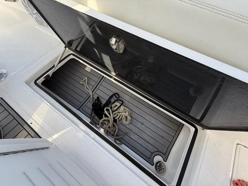 Slide: The Image of 2023 SeaHunter 28 Floridian storage compartment with ropes and accessories. - 35