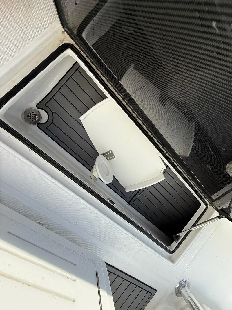 Slide: The Image of 2023 SeaHunter 28 Floridian boat interior with storage compartment and drain. - 36