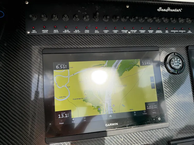 Slide: The Image of 2023 SeaHunter 28 Floridian dashboard with Garmin navigation display and control panel. - 45