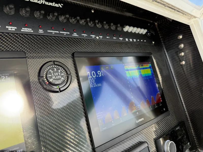 Slide: The Image of 2023 SeaHunter 28 Floridian dashboard with Garmin display and lift plate gauge. - 46