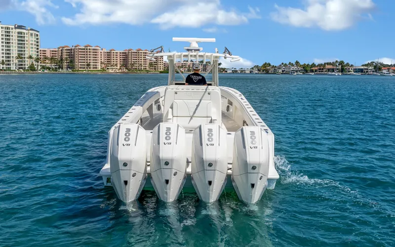 Slide: The Image of 2019 SeaVee 390Z boat with quad engines cruising on clear blue water. - 1