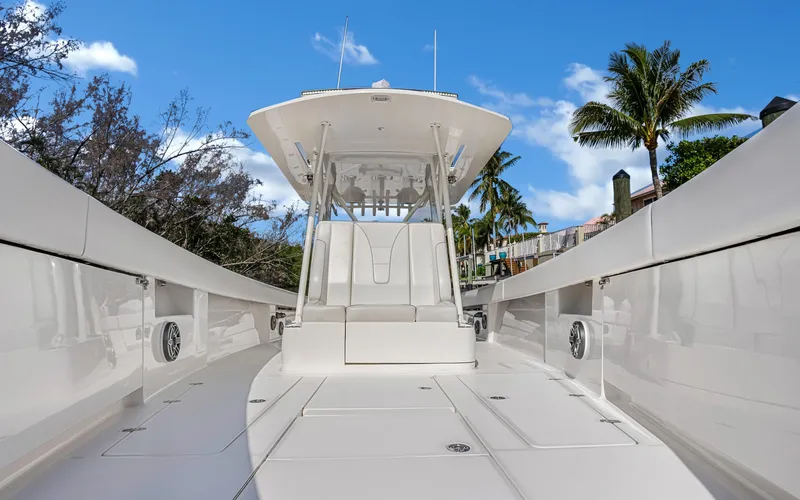 Slide: The Image of 2019 SeaVee 390Z boat with sleek design, docked under clear blue sky. - 14