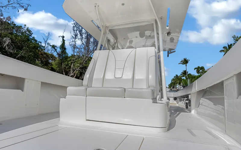 Slide: The Image of 2019 SeaVee 390Z boat interior with sleek seating and canopy under a blue sky. - 15