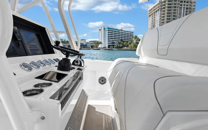 Slide: The Image of 2019 SeaVee 390Z boat interior with modern controls, overlooking waterfront buildings. - 18