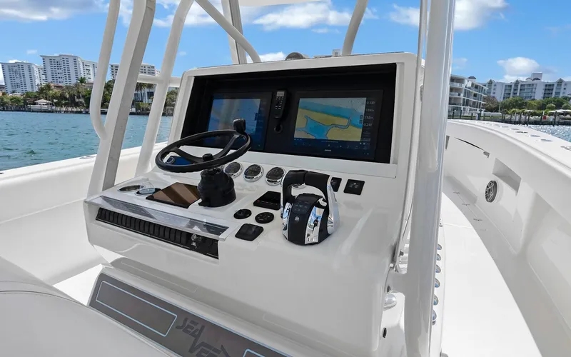 Slide: The Image of 2019 SeaVee 390Z boat console with navigation screens and steering wheel. - 21