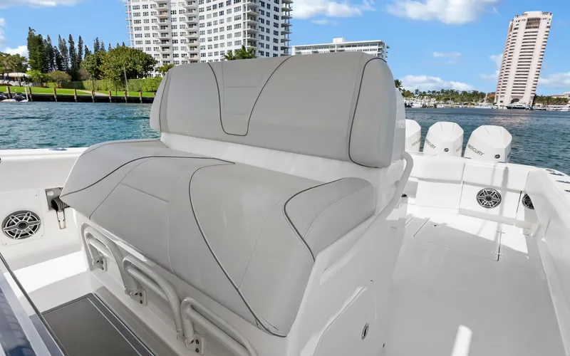 Slide: The Image of 2019 SeaVee 390Z boat with cushioned seating, docked near waterfront buildings. - 22