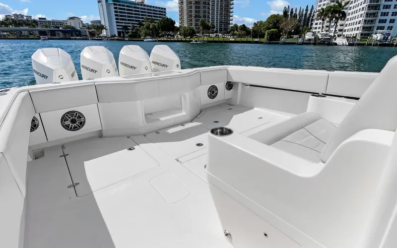 Slide: The Image of 2019 SeaVee 390Z boat deck with Mercury engines, docked near waterfront buildings. - 26