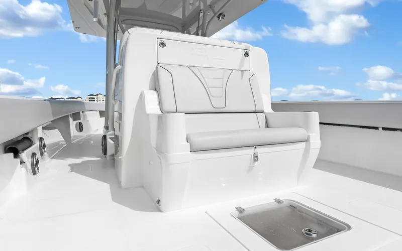 Slide: The Image of 2019 SeaVee 390Z boat interior with white seating under a blue sky. - 30