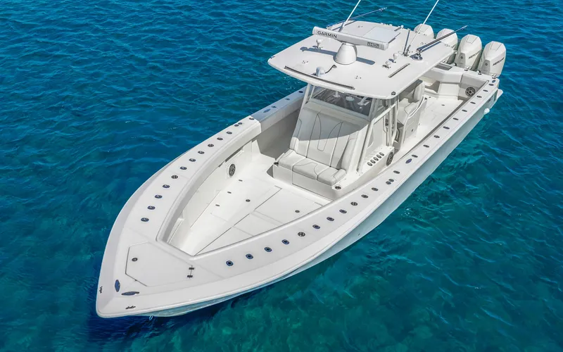 Slide: The Image of 2019 SeaVee 390Z boat on clear blue water, showcasing sleek design and powerful engines. - 8