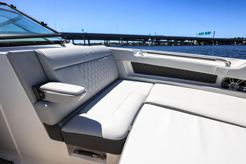 Slide: The Image of 2023 Sea Ray SLX 310 Outboard boat interior with luxurious seating and water view. - 11
