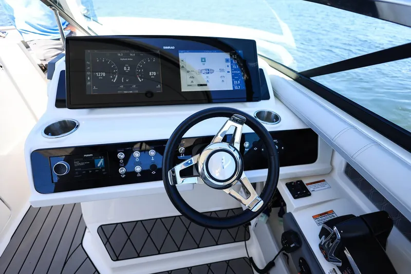 Slide: The Image of 2023 Sea Ray SLX 310 Outboard helm with advanced controls and navigation display. - 14