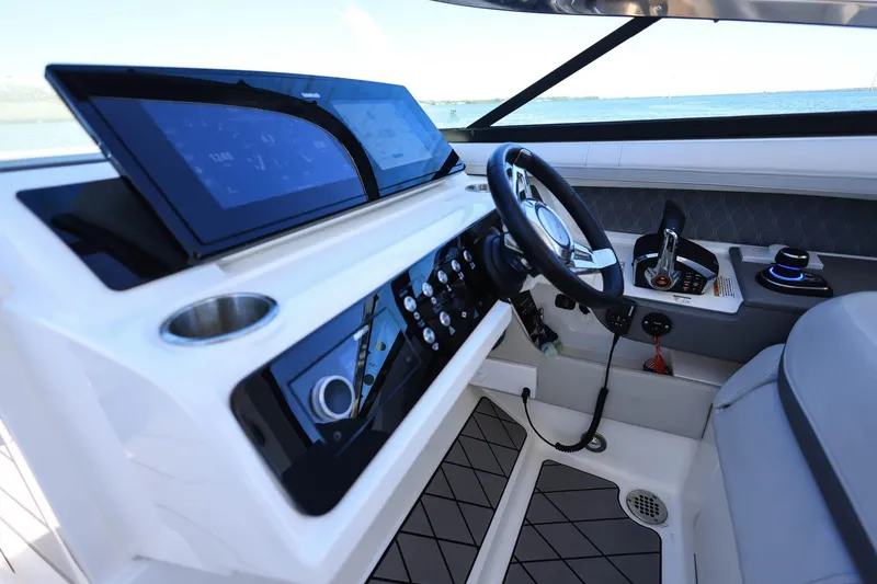 Slide: The Image of 2023 Sea Ray SLX 310 Outboard helm with modern controls and sleek dashboard design. - 15