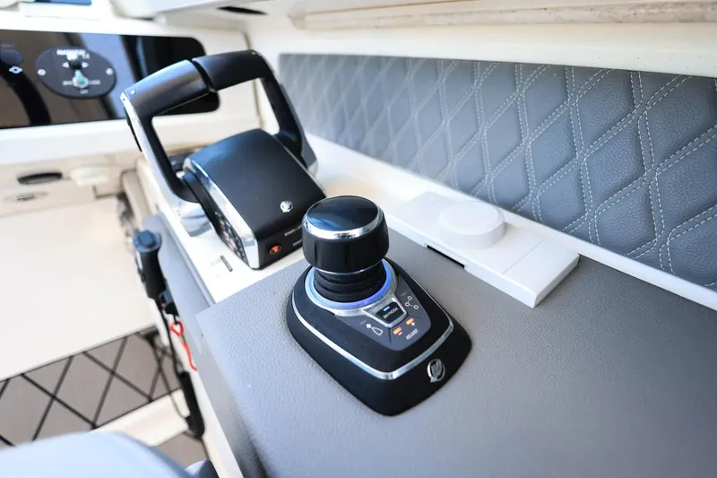 Slide: The Image of 2023 Sea Ray SLX 310 Outboard control panel with joystick and throttle. - 17