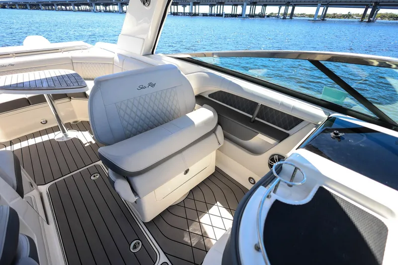 Slide: The Image of 2023 Sea Ray SLX 310 Outboard interior with luxurious seating and scenic water view. - 19