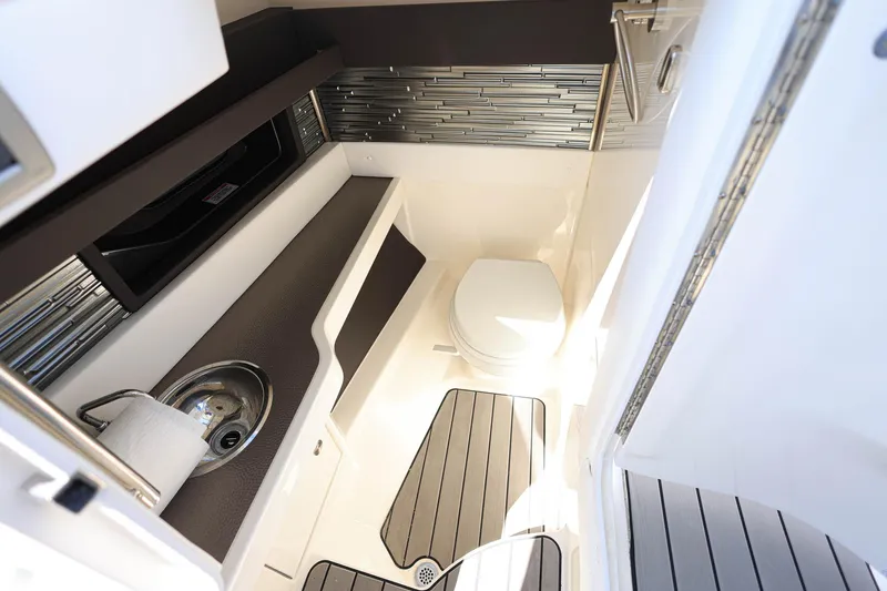 Slide: The Image of 2023 Sea Ray SLX 310 Outboard boat interior with toilet and sink. - 21