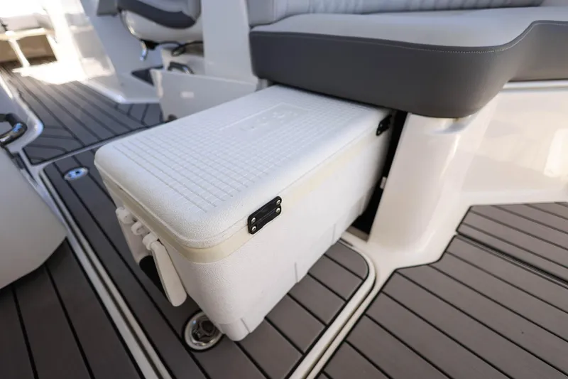 Slide: The Image of 2023 Sea Ray SLX 310 Outboard interior with integrated cooler and seating. - 24