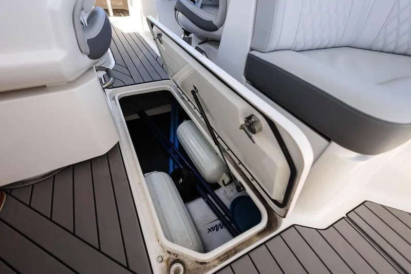 Slide: The Image of Storage compartment on 2023 Sea Ray SLX 310 Outboard boat, featuring sleek seating and deck design. - 25
